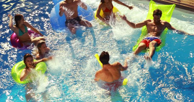 Group of friends having fun in swimming pool, splashing water, enjoying summer on inflatable floats. Perfect for summer activities, vacations, relaxation, youth fun, and social gatherings themes.