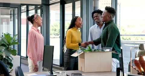 Colleagues Welcoming New Team Member in Office Setting