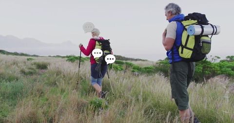 Senior couple hiking coastal dunes enjoying nature adventure