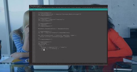 Team Collaborating Over Code with Terminal Window on Laptop at Glass Conference Table