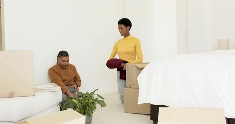 Couple Unpacking in Modern Bedroom, Embracing New Home Lifestyle
