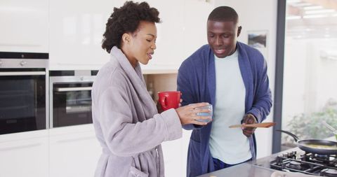 Happy African American Couple Sharing Morning Coffee in Modern Kitchen