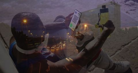 Man Holding Smartphone with COVID-19 Vaccination Passport Amid City Lights - Download Free Stock Images Pikwizard.com