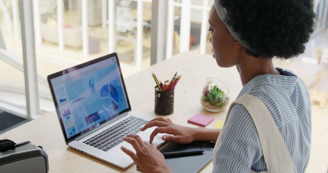 Young Woman Analyzing Data on Laptop in Casual Workspace - Download Free Stock Images Pikwizard.com