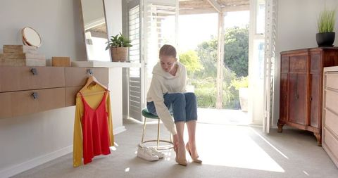 Woman Dressing in Stylish Bedroom Morning Light