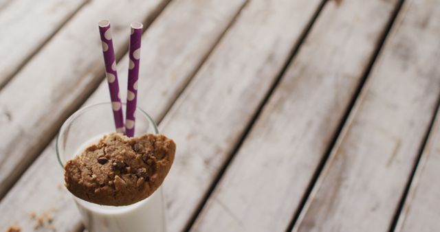 Glass of milk with cookie and purple striped straws on rustic wooden table - Download Free Stock Images Pikwizard.com