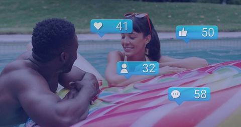 Joyful Couple Engaging with Social Media While Relaxing by Pool