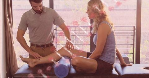 Therapist assisting woman with leg rehabilitation and dna depiction