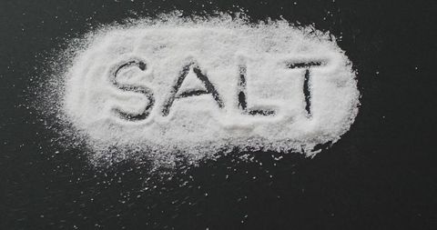 Salt text displayed on black surface emphasizes cooking and ingredients