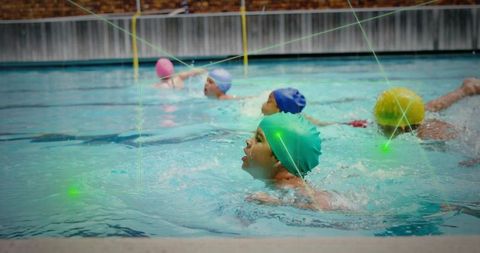 Youth swimmers practicing crawl stroke with swim caps in lap pool