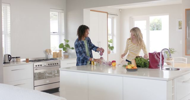 Happy Couple Unpacking Groceries in Bright Modern Kitchen - Download Free Stock Images Pikwizard.com