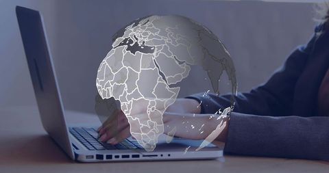 Woman typing on laptop with translucent globe overlay representing global connectivity