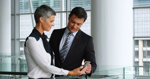 Business Professionals Discussing over Smartphone in Modern Office - Download Free Stock Images Pikwizard.com