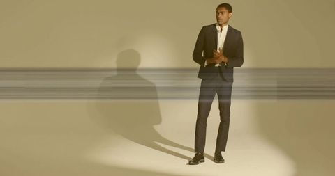 Elegant man in formal suit standing in minimalist setting