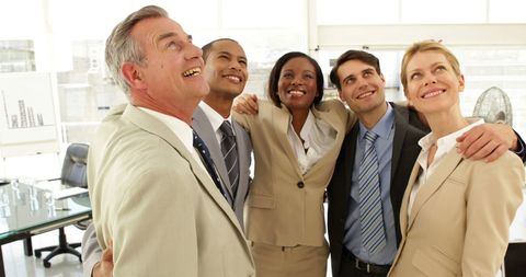 Diverse Business Team Embracing in Office for Team Building