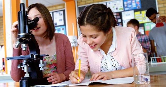 Students Collaborating in Science Classroom with Microscope - Download Free Stock Images Pikwizard.com