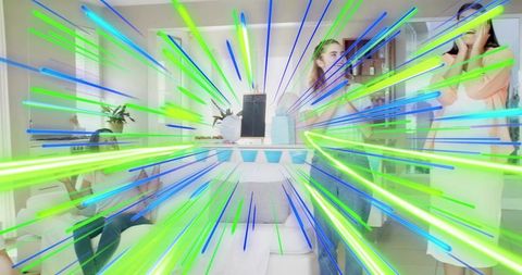 Women celebrating baby shower unboxing gifts in vibrant neon living room