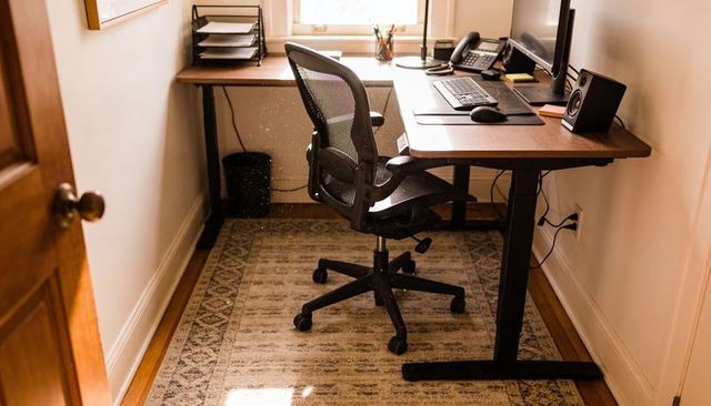 Compact ergonomic home office nook with adjustable standing desk and mesh task chair