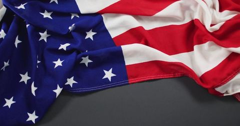 American Flag with Dropped Stars on Gray Surface