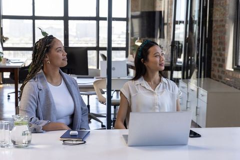 Diverse Coworkers Listening During Office Meeting with Laptop