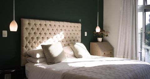Elegant bedroom with beige tufted headboard and modern decor elements
