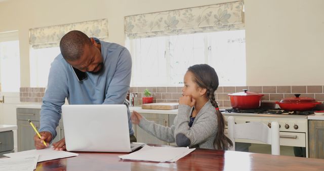 Father working from home while helping daughter with homework - Download Free Stock Images Pikwizard.com