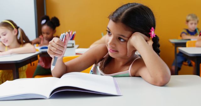 Young Girl Daydreaming While Studying in Classroom - Download Free Stock Images Pikwizard.com