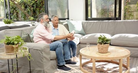 Senior couple exploring modern technology in cozy living room
