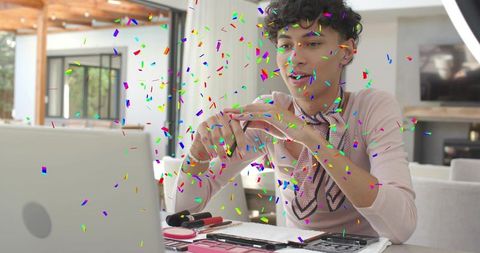 Male beauty influencer holding lipstick during livestream with confetti makeup tutorial