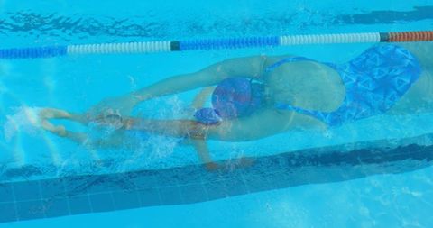 Top View of Woman Swimming Underpool Water