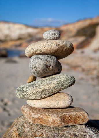 Balanced stones forming a natural sculpture on the beach