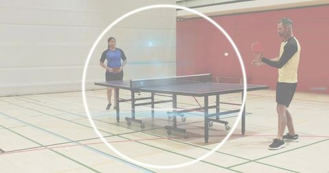 Male and female players serving and returning in fast-paced table tennis match indoor gym