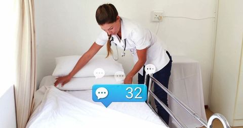 Nurse adjusting hospital bed sheets for patient care