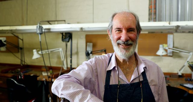 Elderly Craftsman in Workshop Smiling at Camera - Download Free Stock Images Pikwizard.com