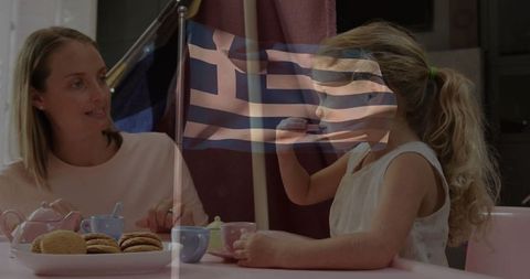 Mother and daughter in playful tea party with greek theme