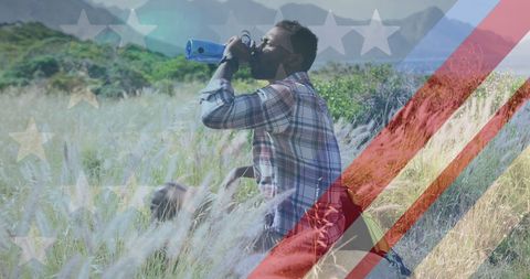African American Man Drinking Water in Mountainous Landscape with American Flag Overlay