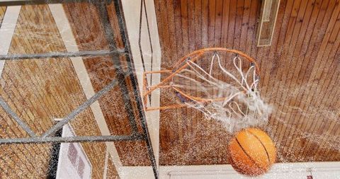 Basketball Scoring Moment in Indoor Gymnasium with Wooden Ceiling