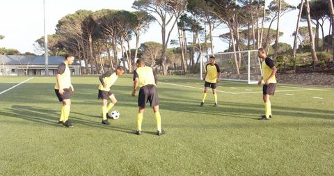 Soccer Team Practicing Drills on Sunny Day Before Match
