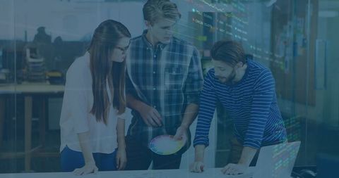 Creative team collaborating in modern office with color charts