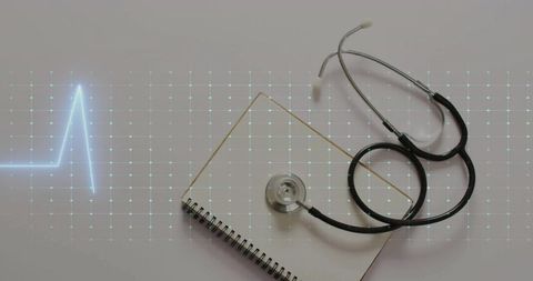 Stethoscope on notepad with digital heartbeat graphic