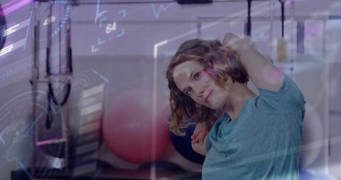 Active Woman Stretching in Innovative Fitness Gym Setting with Holograms