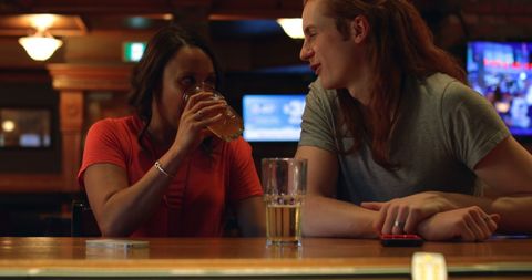 Young Adults Enjoying a Relaxed Conversation at a Bar