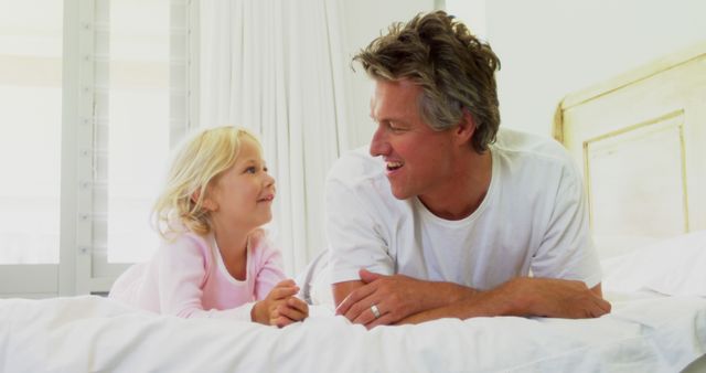 Father and Daughter Bonding on Bed in Bright Bedroom - Download Free Stock Images Pikwizard.com