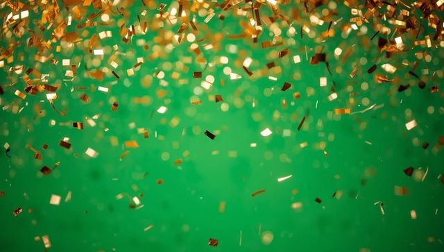 Glittering Gold Confetti Against Vibrant Green Background