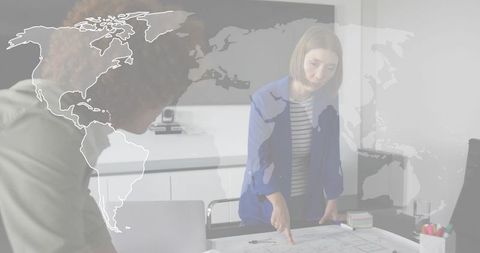 Team planning global strategy pointing at blueprint in boardroom with world map overlay