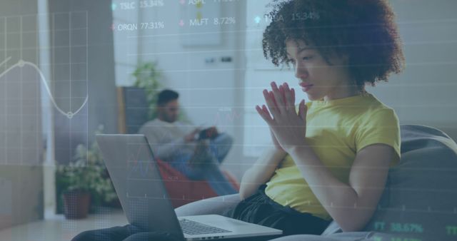 Woman Concentrating on Laptop with Digital Financial Data Overlay - Download Free Stock Images Pikwizard.com