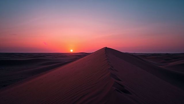 Sunset Over Majestic Desert Dunes with Glowing Horizon