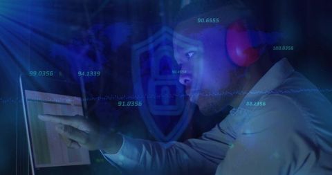 Cybersecurity analyst pointing at laptop dashboard with neon data overlays