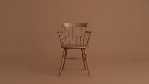 Vintage wooden spindle-back armchair on monochrome background