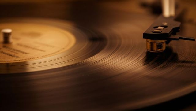 Vintage vinyl record spinning under soft amber light